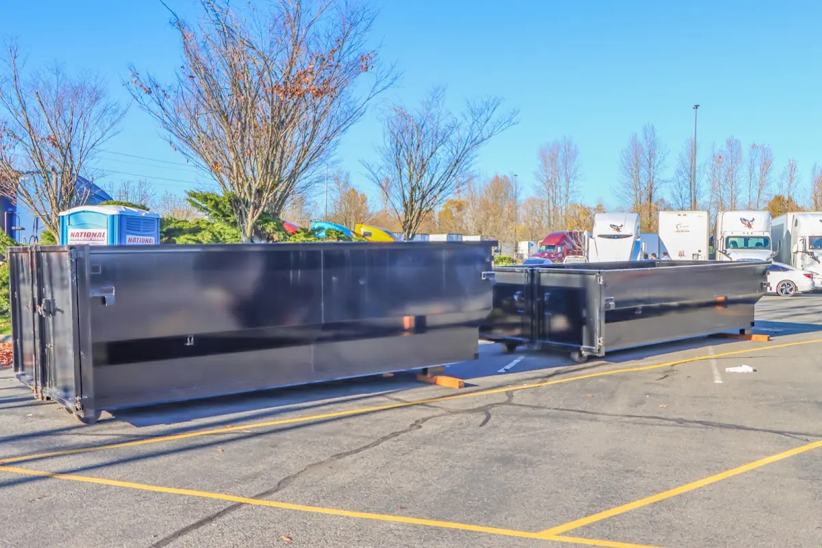 Professional dumpster rental service with roll-off container on residential driveway in Broken Arrow